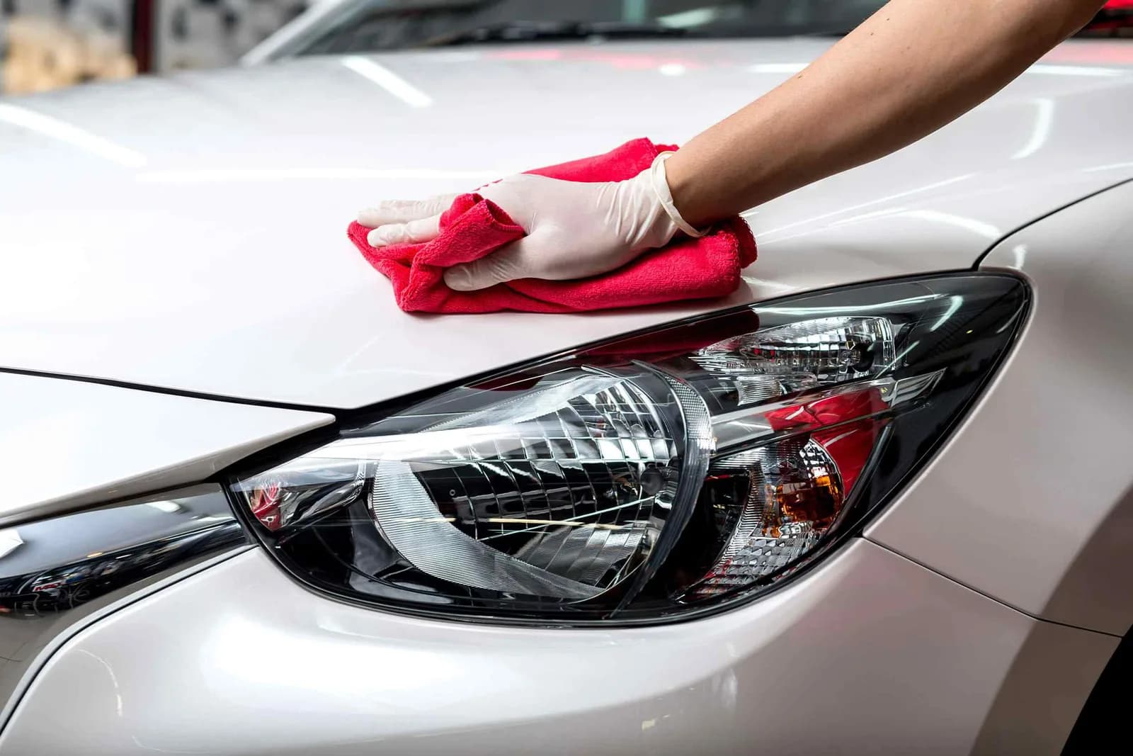 Technician wiping down a freshly protected vehicle finish